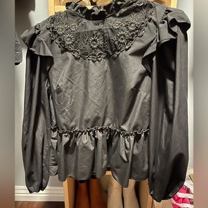 Medium black ruffled long sleeve black shirt.